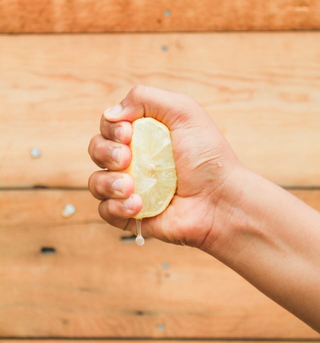 Fist squeezing a lemon